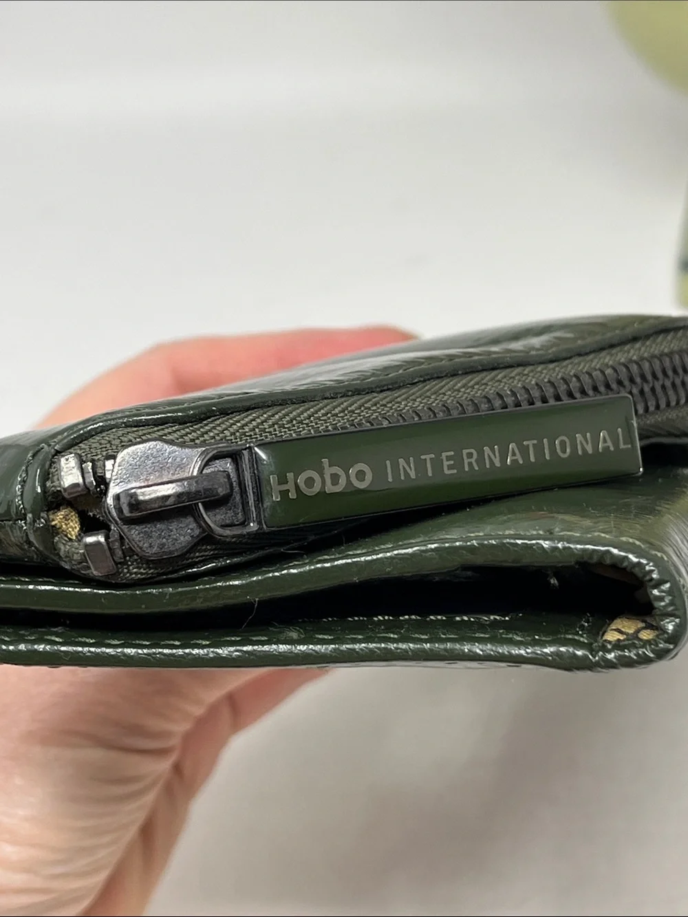 HOBO INTERNATIONAL CLUTCH WALLET ASYMMETRICAL ZIPPER PATENT LEATHER FOREST GREEN